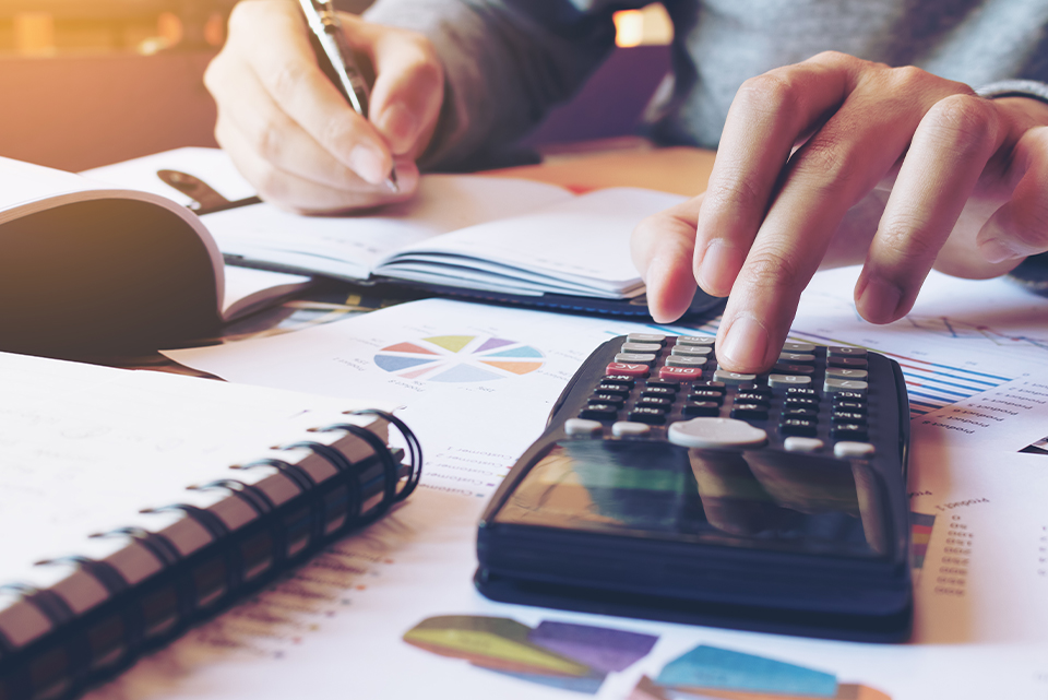 a table with paperwork and a calculator